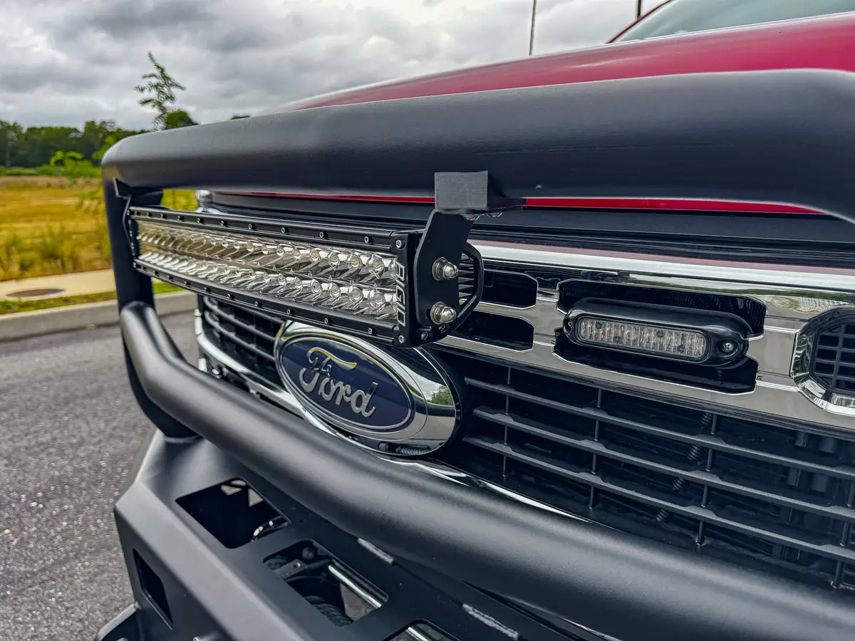 Front bumper close-up showing winch drum visible behind bumper opening.